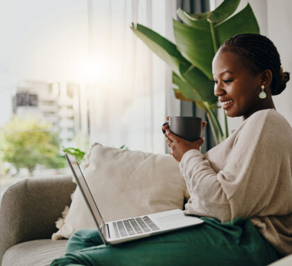 Shot of a young woman listening to hear music on her headphones at home