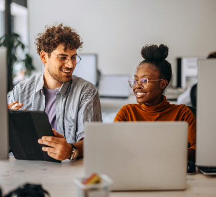 Two young colleagues working together at modern office