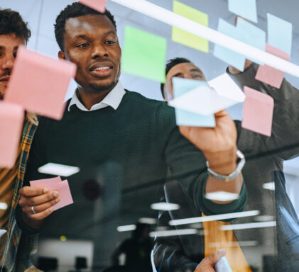 Portrait of a diverse team using stickers for a project management.