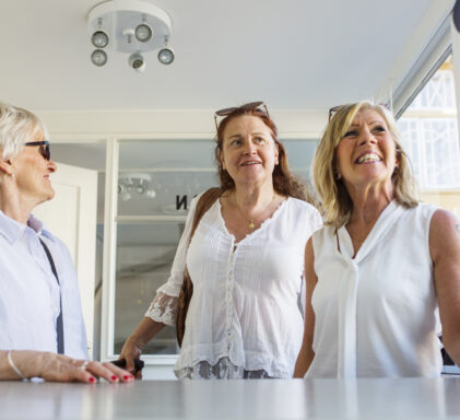 Three women at hotel reception desk