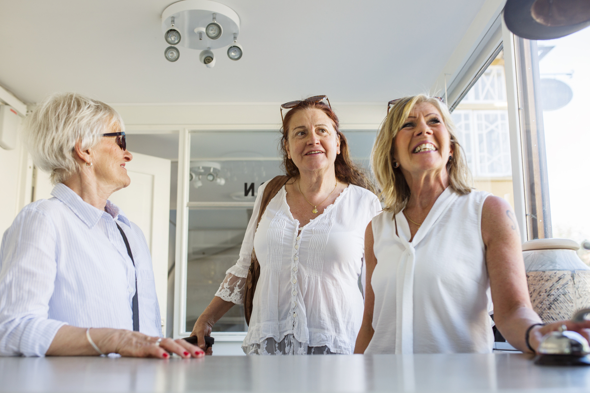 Three women at hotel reception desk