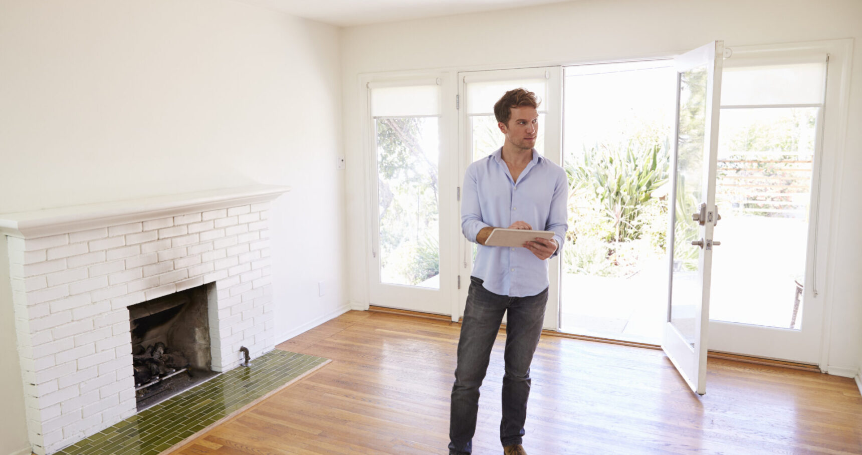 male realtor with digital tablet looking around ho 2026 01 05 22 59 54 utc