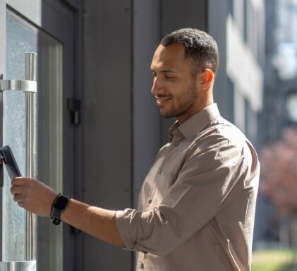 A man unlocking a smart lock with his phone.