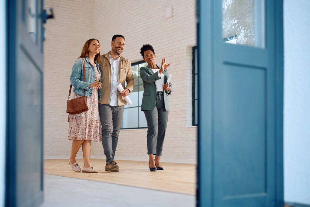 Happy Couple Touring Home with Friendly Agent